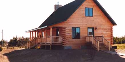 A log sided cabin with a nice covered porch