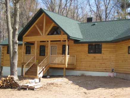 A ranch style half log home near North Branch, MN