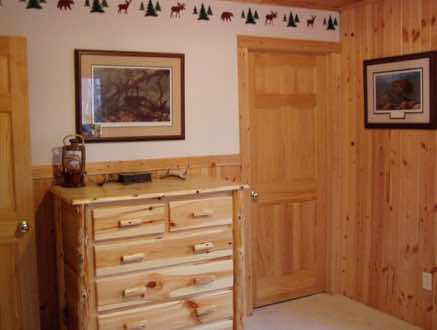 A mix of knotty pine and drywall in a bedroom